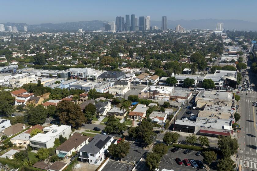 LOS ANGELES, CA - October 18: The city proposed a 33-bed interim homelessness shelter at a current parking lot, lower center, at Midvale Avenue and Pico Boulevard in Los Angeles. The project will provide onsite laundry, housing units with ensuite bathrooms and services for people experiencing homelessness. Some neighbors oppose the project arguing that it will be too close to residential areas. Photographed in Westside on Wednesday, Oct. 18, 2023 in Los Angeles, CA. (Myung J. Chun / Los Angeles Times)