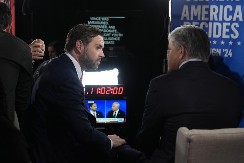 Republican vice presidential nominee Sen. JD Vance, R-Ohio, speaks to Sean Hannity on the Fox News Channel in the spin room after a CBS News vice presidential debate against Democratic vice presidential nominee Minnesota Gov. Tim Walz, Tuesday, Oct. 1, 2024, in New York. (AP Photo/Julia Demaree Nikhinson)