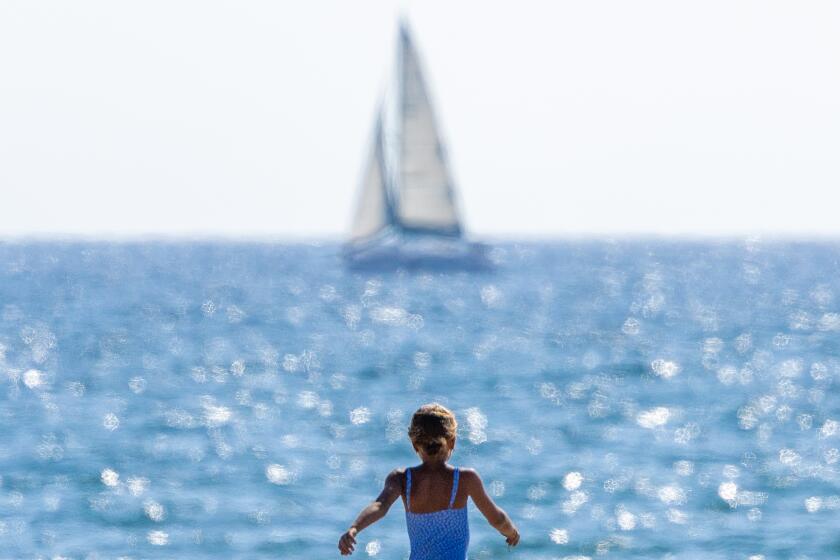 Huntington Beach, CA - August 30: Beach goers kick off the Labor Day weekend amidst warm weather and sunny skies at Bolsa Chica State Beach in Huntington Beach Friday, Aug. 30, 2024. (Allen J. Schaben / Los Angeles Times)