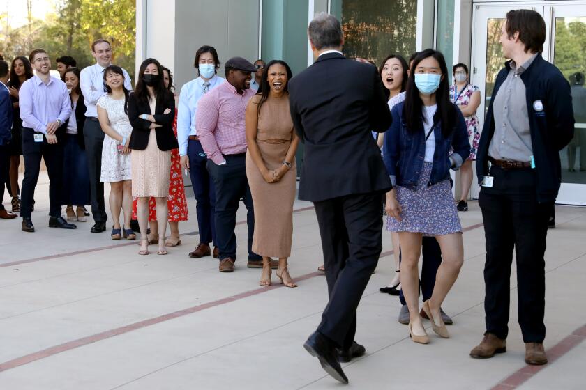 LOS ANGELES, CA - MARCH 18: Lee Todd Miller, associate dean of pediatricts, with 155 future doctors before they open residency acceptance envelopes on Match Day at the David Geffen School of Medicine at UCLA on Friday, March 18, 2022 in Los Angeles, CA. Match Day is when medical students nationwide learn which hospital has accepted them for residency, or advanced training in their chosen clinical specialty. Due to COVID-19, this was the first in-person Match Day ceremony since 2019. (Gary Coronado / Los Angeles Times)