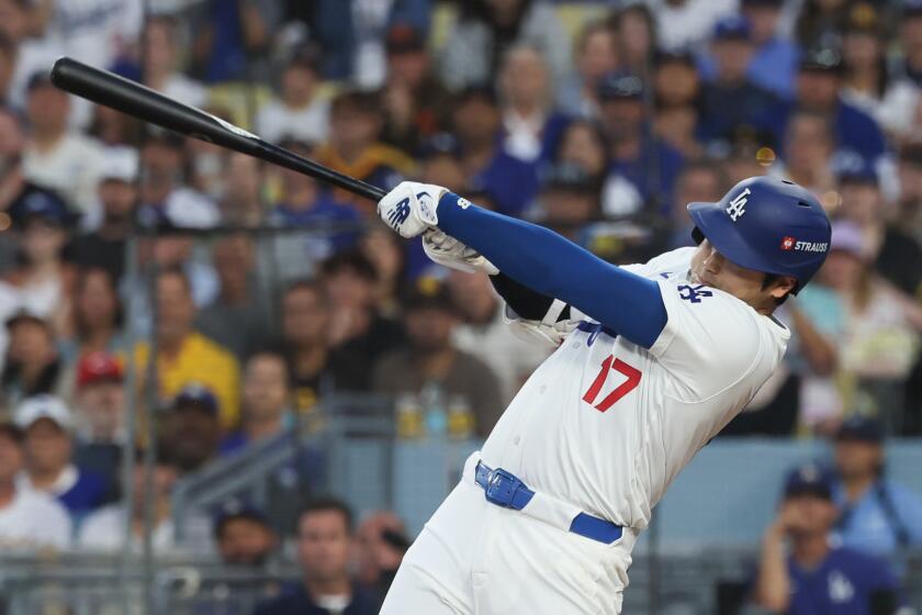 LOS ANGELES, CALIFORNIA - OCTOBER 05: Shohei Ohtani #17 of the Los Angeles Dodgers hits a three-run.