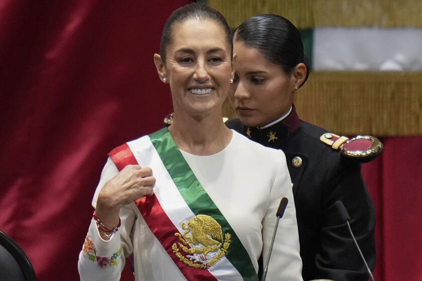 President Claudia Sheinbaum wears the presidential sash during her swearing-in ceremony as Mexico's new president in Mexico City, Tuesday, Oct. 1, 2024. (AP Photo/Eduardo Verdugo)