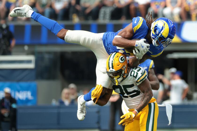 The Rams' Demarcus Robinson makes a catch over Packers cornerback Keisean Nixon.