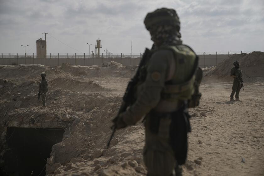 Israeli soldiers take up positions next to an entrance of a tunnel which the military says Hamas militants used in the southern Gaza Strip, about a 100 meters from the Philadelphi Corridor along the border with Egypt, during a ground operation on Friday, Sept. 13, 2024. (AP Photo/Leo Correa)