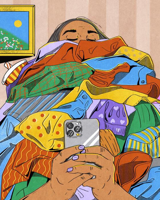 A women holds a pile of clothes 