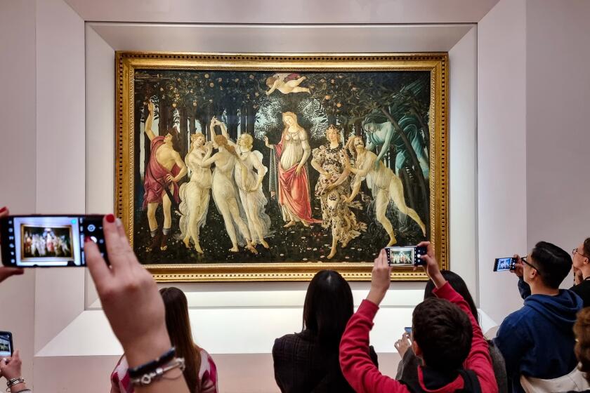 Visitors view and photograph the painting Primavera by the 15th century Italian Renaissance artist Sandro Botticelli